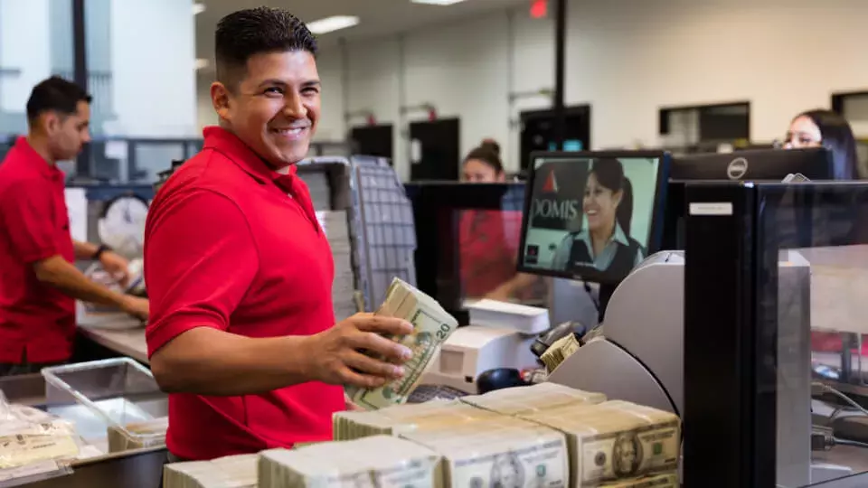 Loomis employee processing cash