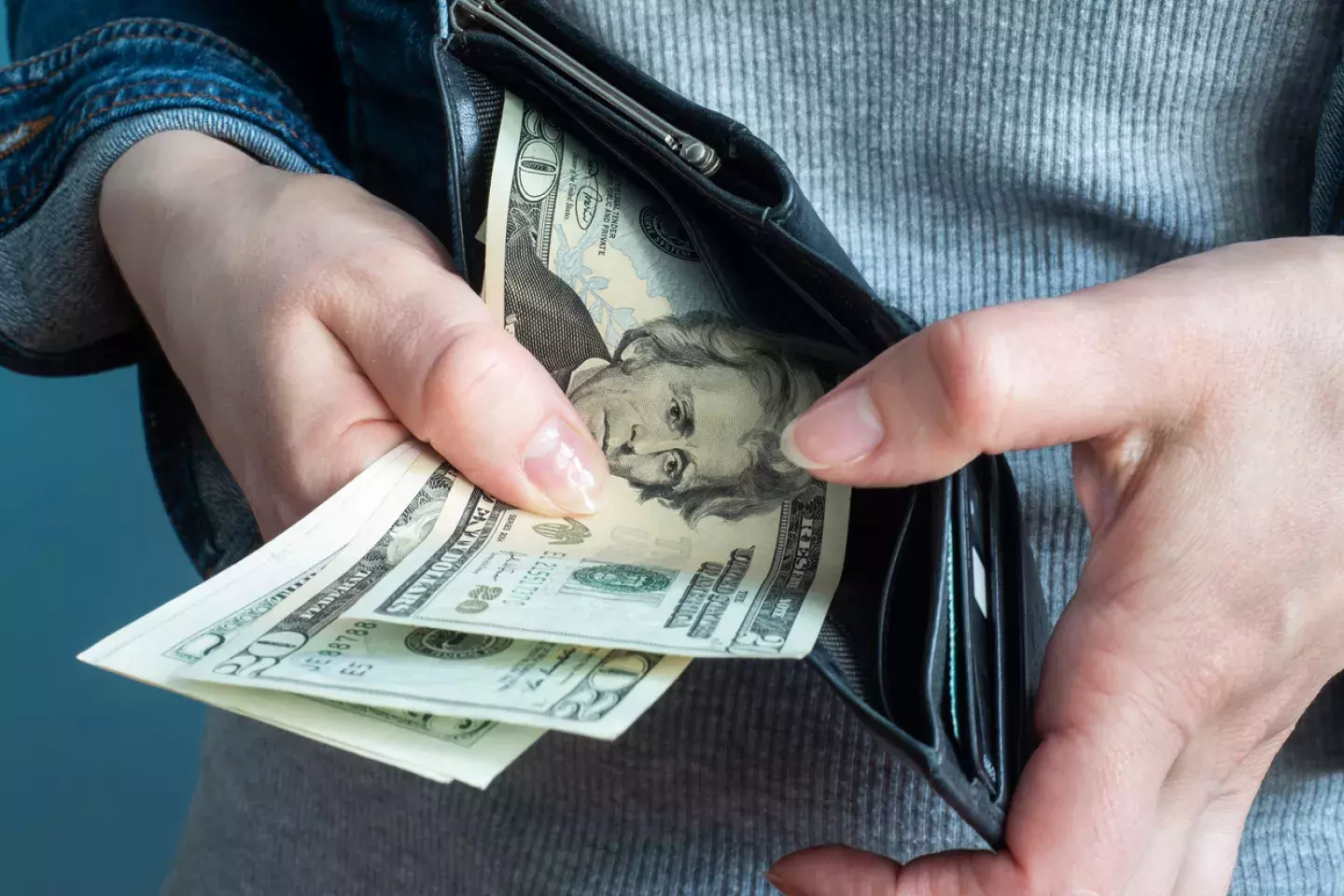 Woman pulling money out of wallet